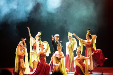 troupe of Asian performers on stage